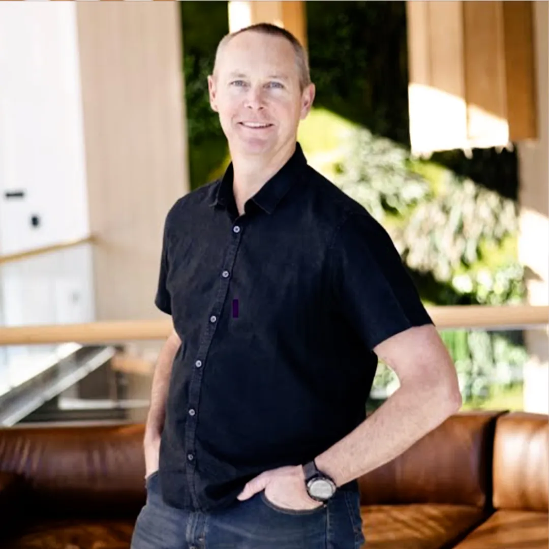 Professional headshot of Andrew Savage in a business setting